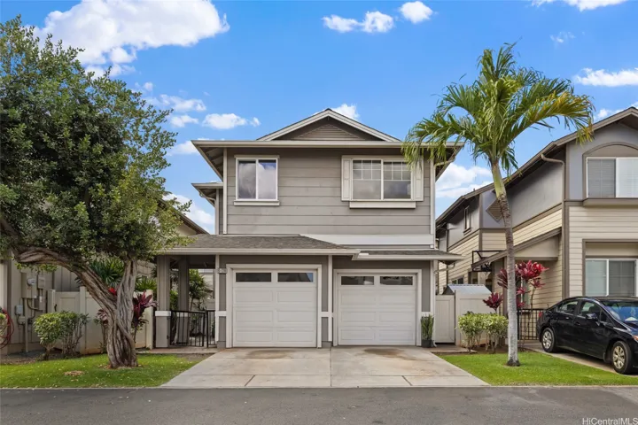 The property features a two-car garage with additional parking for two vehicles on the driveway.