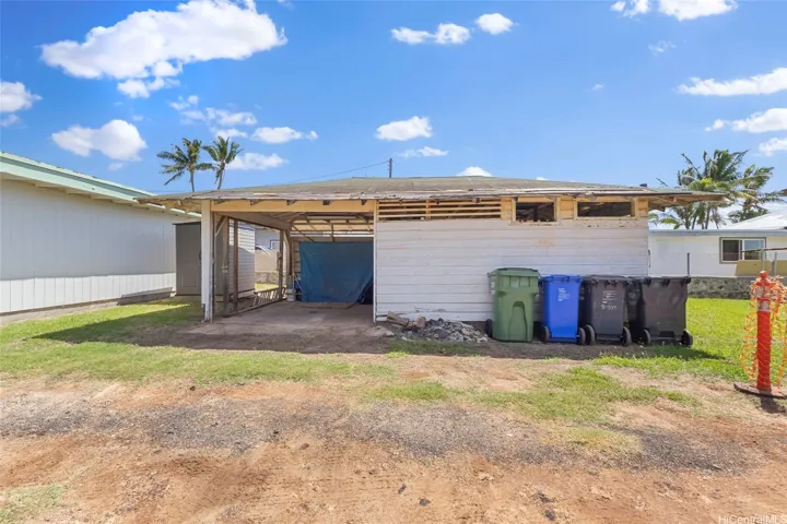 Carport/storage structure on left side property.