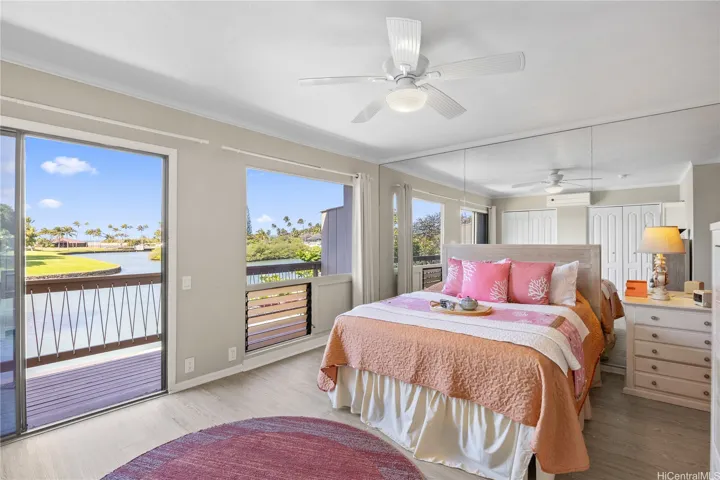 Your primary bedroom looks out toward the marina with a backdrop of the ocean