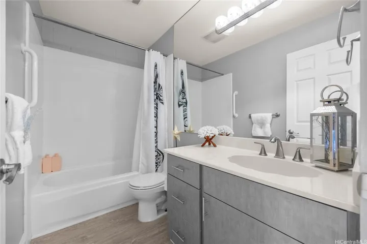 Upstairs hallway bath with newer vanity and luxury vinyl flooring