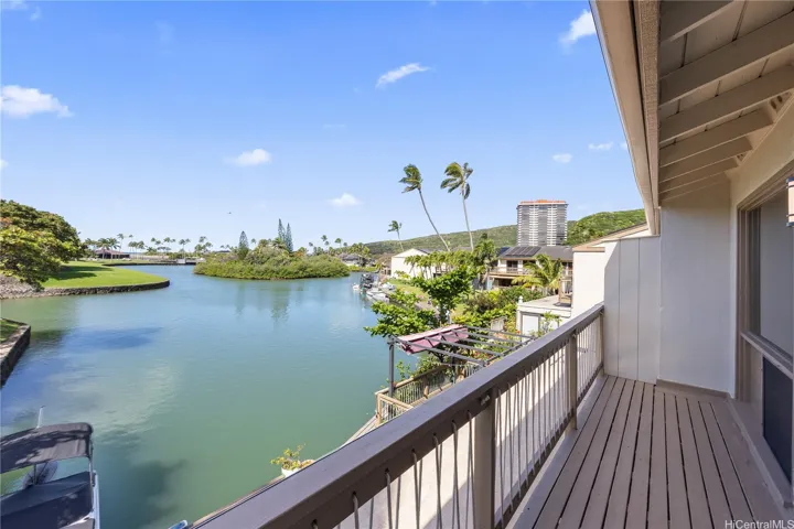 A view from the primary bedroom lanai looking out toward the ocean and marina