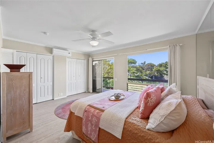 Your primary bedroom looks out toward the marina with a backdrop of the ocean