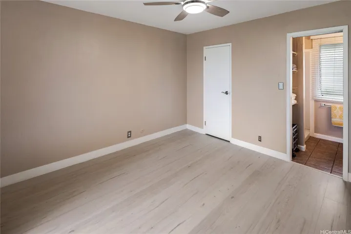 Right side of the main bedroom with walk-in closet & entrance to the shower room. Enhanced photo.