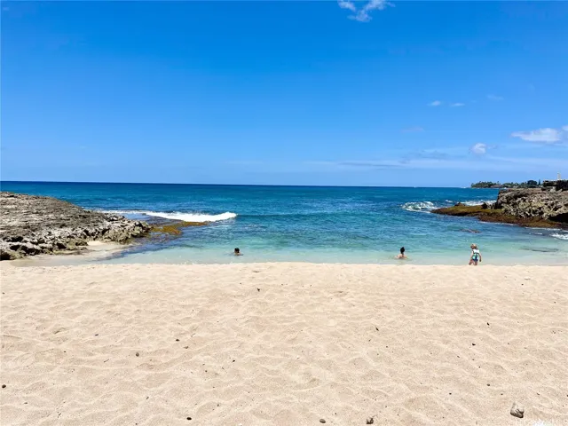 Nearby Sandy Beach (accessible via reef shelf or road beach access)