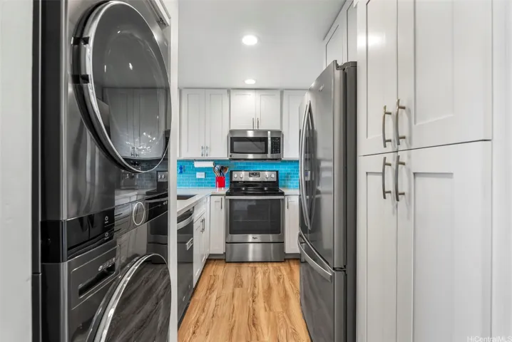 A newer, full sized washer/dryer stack combination.