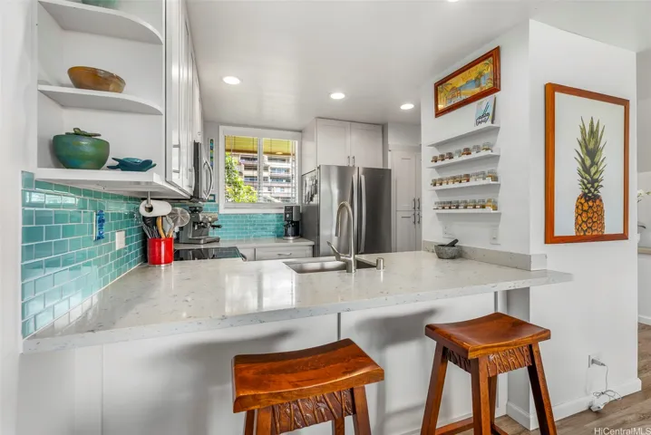 Open kitchen and counter seating is ideal to carry on great conversations with friends and family
