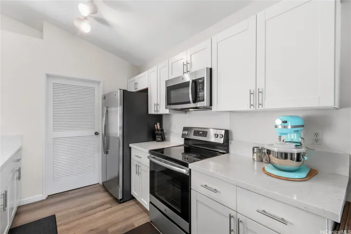  Modern, chef-inspired kitchen featuring updated cabinets and sleek countertops. The heart of this move-in-ready home.
