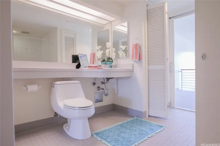 Spacious bathroom! You can see the shower stall reflected in the mirror.