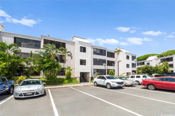Community exterior with assigned parking convenience.