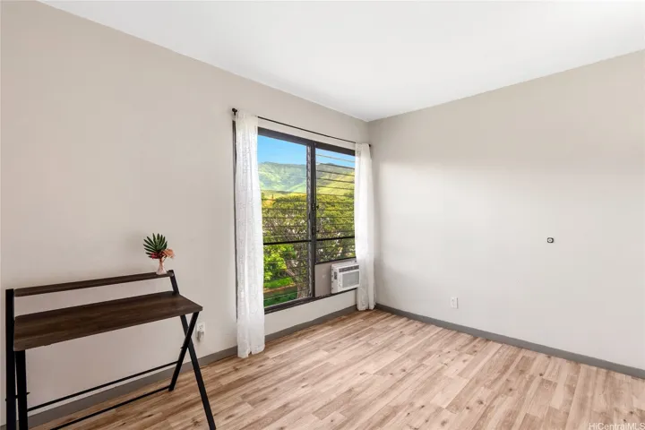 Additional bedroom angle showing window light and usable space.