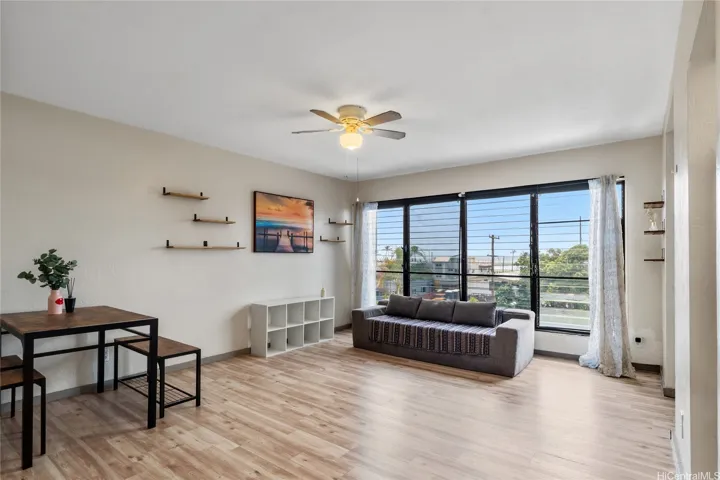 Bright living area with wide windows and an open, comfortable feel.