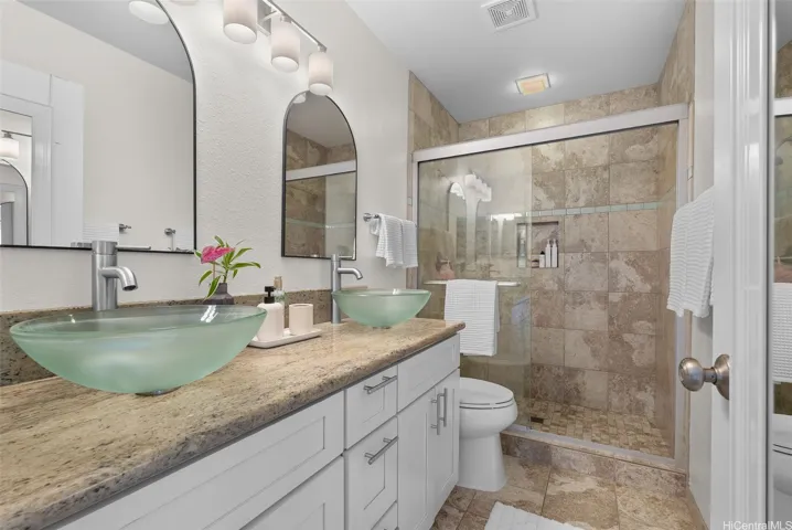 Primary bathroom with dual vanity and walk-in shower
