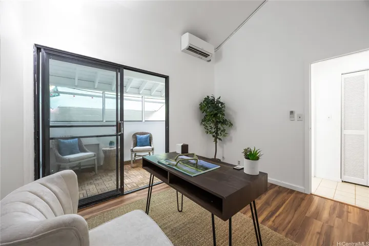 Third bedroom with access to a sun lit enclosed courtyard staged as an office