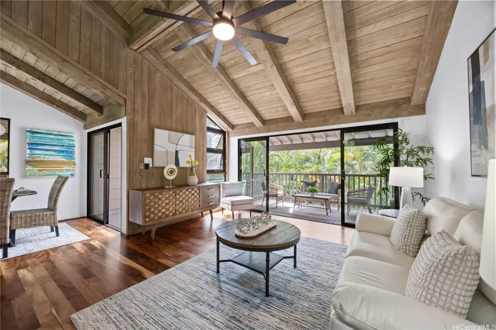Vaulted ceilings and koa floors adorn your living room which flows to your covered lanais