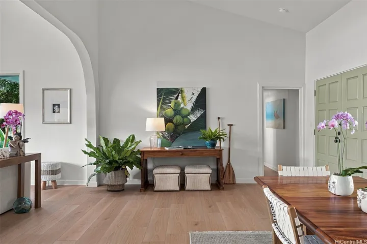 Warm and welcoming entry with soaring ceilings, flowing into a bright, open living space