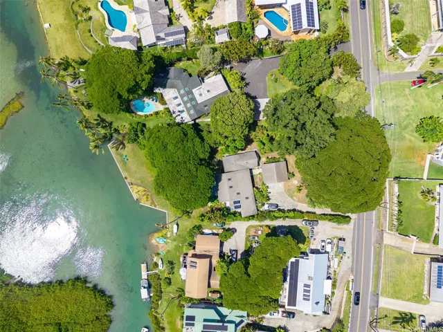 Stunning aerial drone view of the property grounds extending from Kaneohe Bay Drive to the water, showcasing the expansive potential for a pool or additional home.