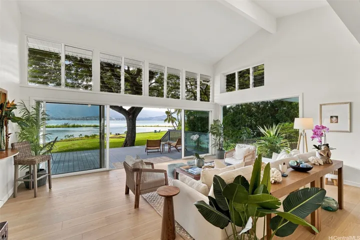 Stunning views from the living area, with expansive windows and sliding glass doors that seamlessly integrate the beautiful outdoor scenery.