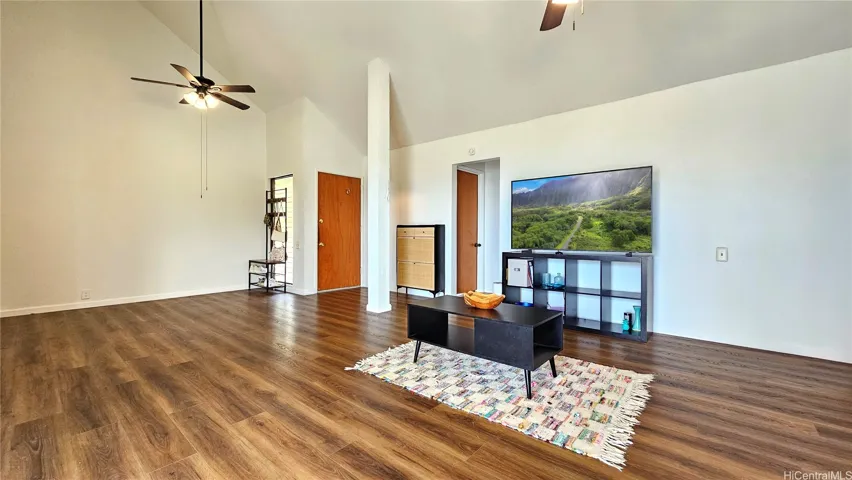 Another view of the spacious living space facing the front entrance and downstairs bedroom and bathroom entrance.