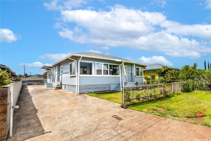 Front and side of house - cute front yard, long driveway for multiple cars