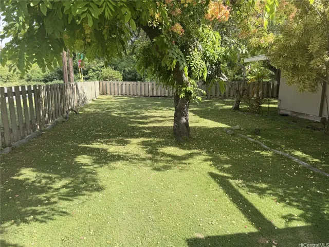 Large and level lot with lots of shade as well as fruit trees.