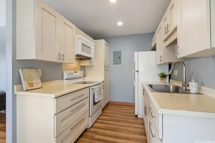 Large drawers for a modern touch to the kitchen.  Recessed lighting.