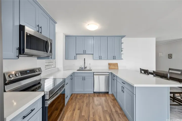 Stylishly updated kitchen showcasing quartz counters and upgraded appliances.