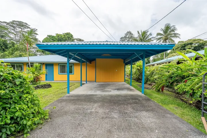 Drive through your double gate filled with fragrant Lilikoi vines right into your covered carport
