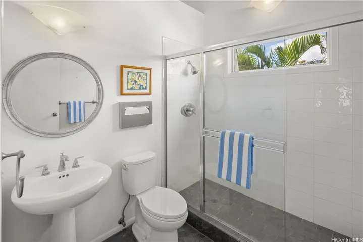 Main level bathroom includes a high ceiling and big walk-in shower.