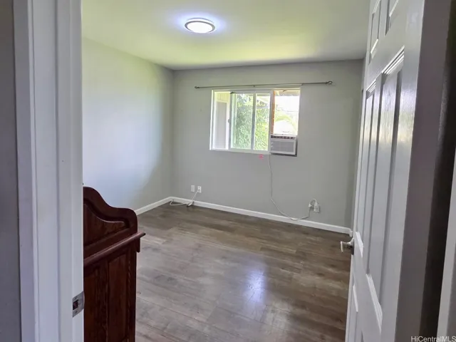 Versatile bedroom or home office space with peaceful garden views.