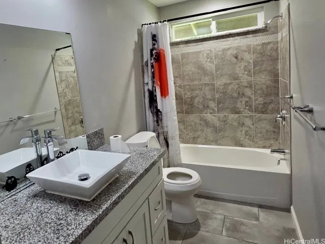 Well-appointed bathroom with contemporary finishes and tiled shower surround.