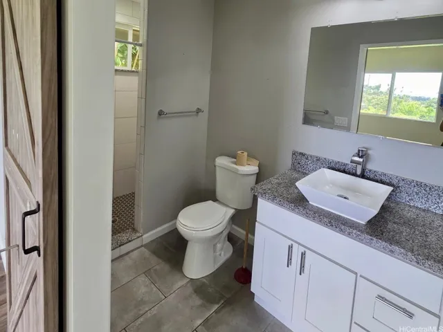 Modern bathroom with updated vanity, storage, and clean contemporary finishes.