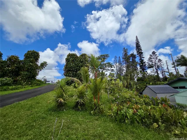 Mature palms and ornamental landscaping create a peaceful Hawai?i-inspired setting.