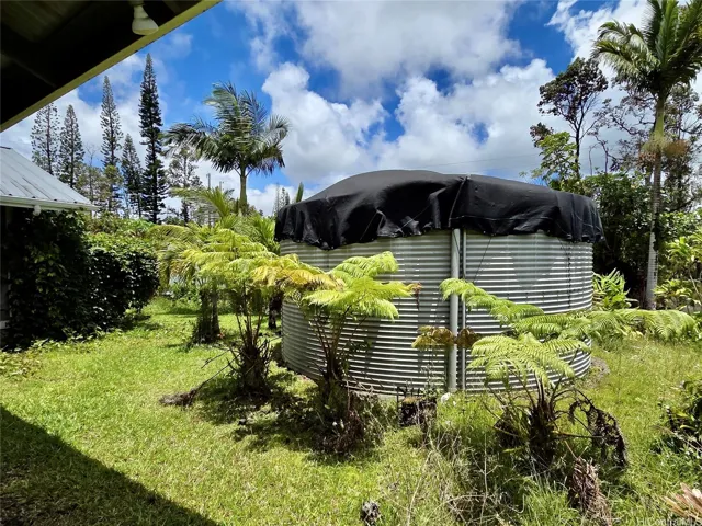 Mature palms and ornamental landscaping create a peaceful Hawai?i-inspired setting.