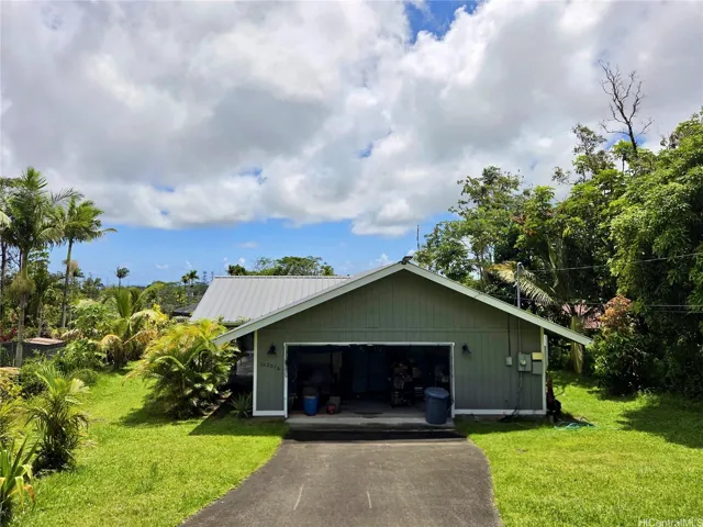 Welcome home to this spacious Ainaloa property featuring tropical landscaping, open skies, and an enclosed garage.