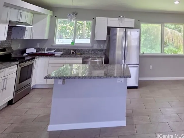 Spacious kitchen featuring modern cabinetry, ample counter space, and stainless-steel appliances.