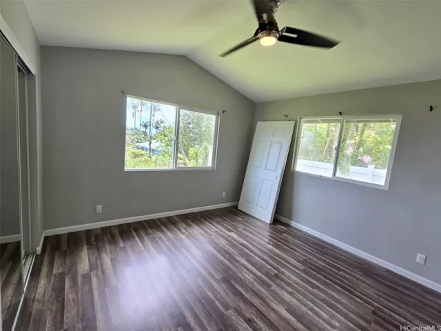 Bedroom featuring stylish flooring, ample natural light, and convenient access to bath.