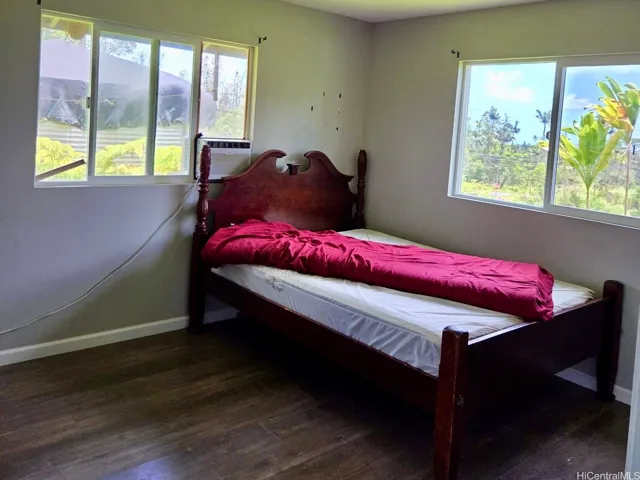 Bright secondary bedroom with multiple windows and excellent airflow.