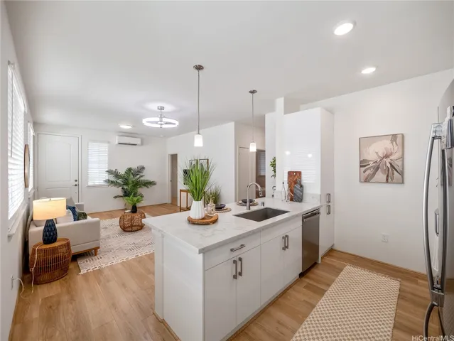 Upgraded with warm wood-tone luxury vinyl plank flooring in main living areas.