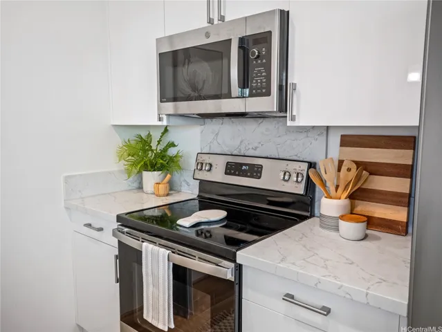 Coordinated suite of stainless steel GE appliances compliment the kitchen design.