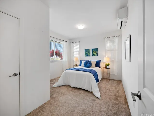 Primary bedroom with a full bath and split A/C for personalized comfort and upgraded carpet.  Walk in closet is to the left.