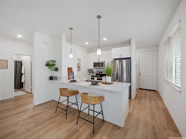 The generous sit-down counter offers plenty of space for dining, can double as a workspace, and adds to the home’s efficiency.