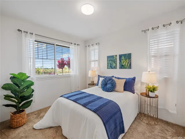Primary bedroom with walk-in closet and full bath.  Large windows bring in lots of natural light.  Plush upgraded carpet.