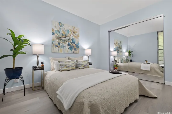 The first bedroom with double mirrored closet doors