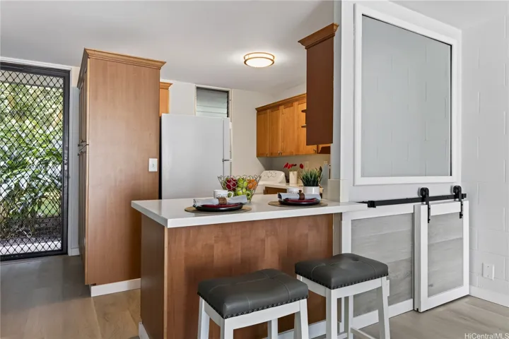 Enjoy a quick meal here on the counter or dine on the dining table. Storage cabinet near door has lighting on the top.