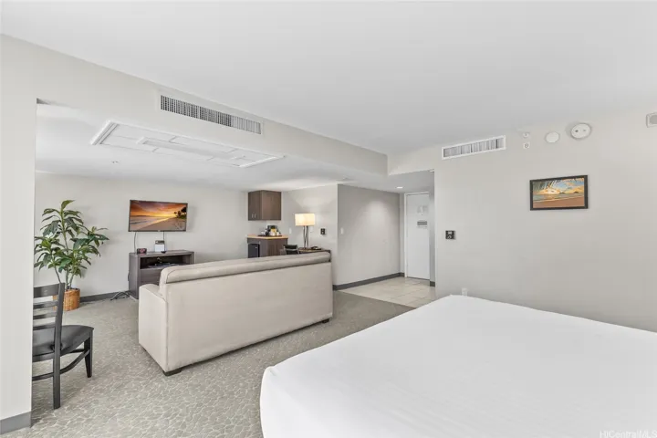 King Size bed with high ceilings, sleeper sofa in the living room.