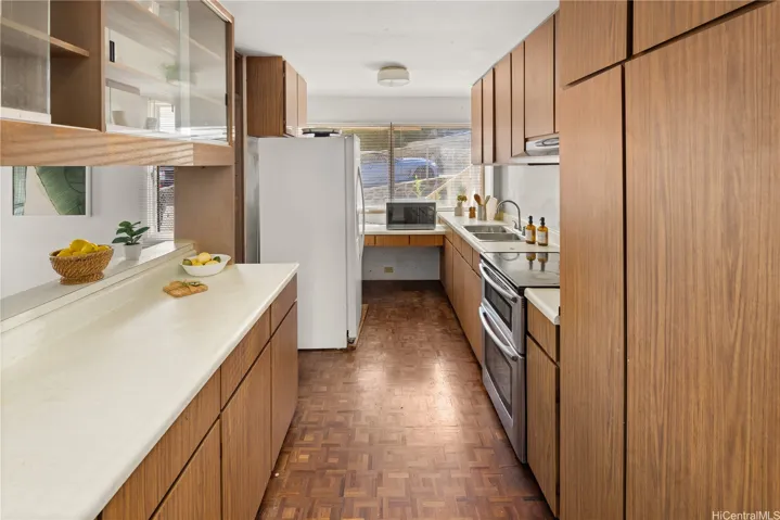 The galley-style kitchen opens into the dining​​‌​​​​‌​​‌‌​‌‌​​​‌‌​‌​‌​‌​​​‌​​ area.