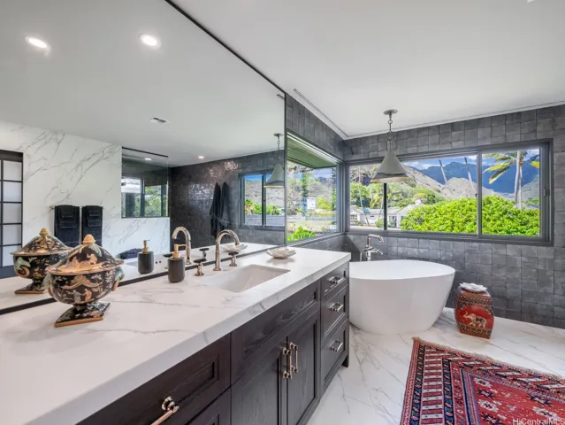 Primary bathroom, stand alone tub and stunning tiled shower.