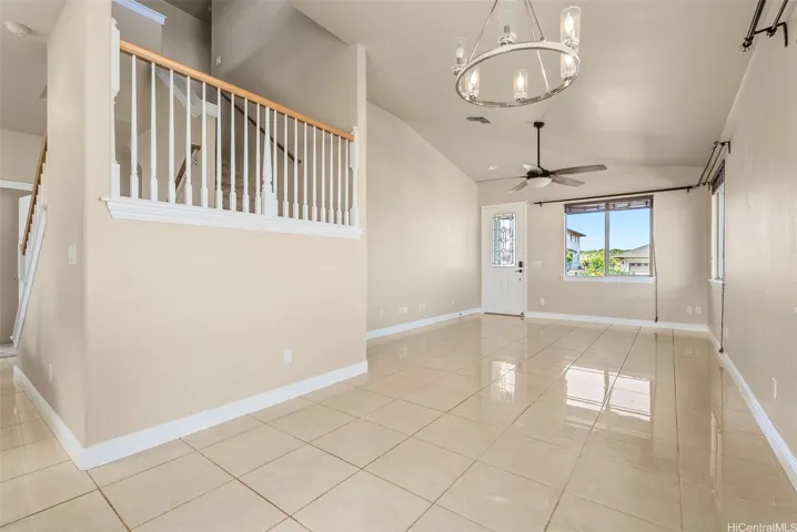 Open dining area flowing into the living room and accessible to the back covered lanai and yard
