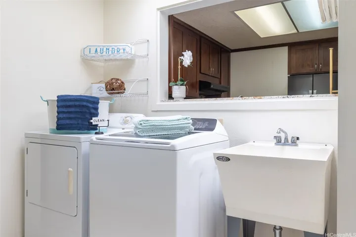 Interior laundry area with full size washer and dryer.