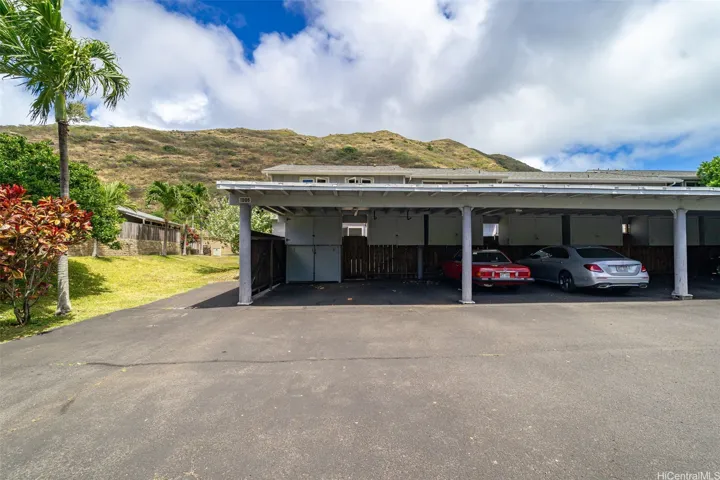 Two-car carport with spacious storage units.